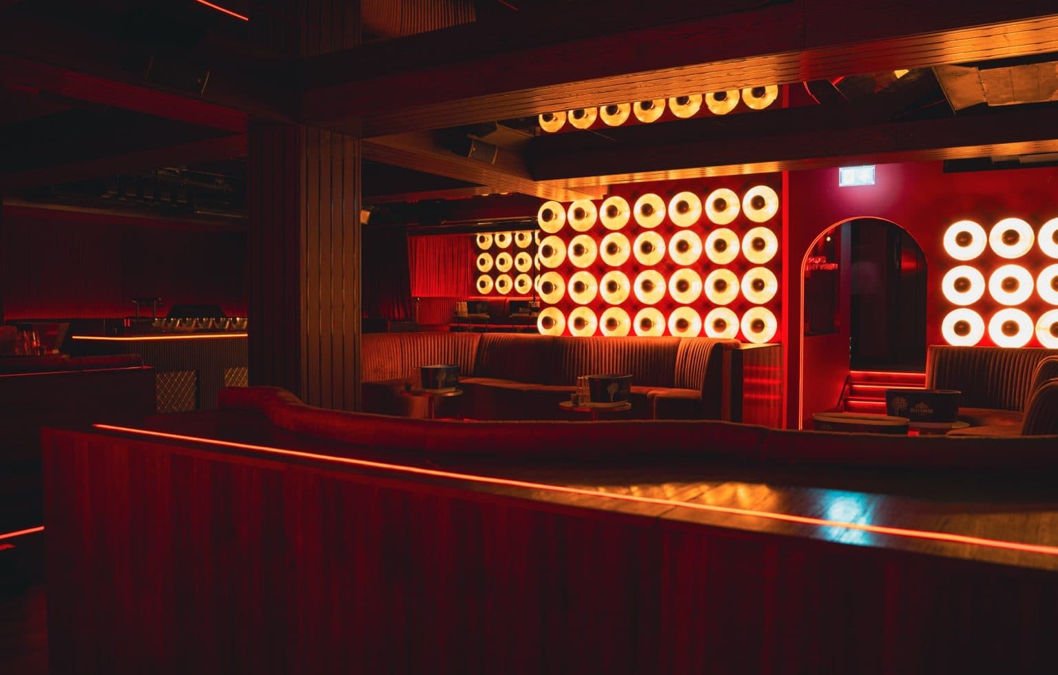 The room at Rumour, formerly Tabu, on Dover Street: booths beneath the backlit gold disc walls