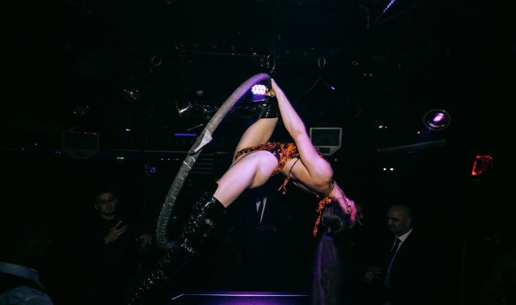 Aerialist performing inside Funky Buddha club in London.