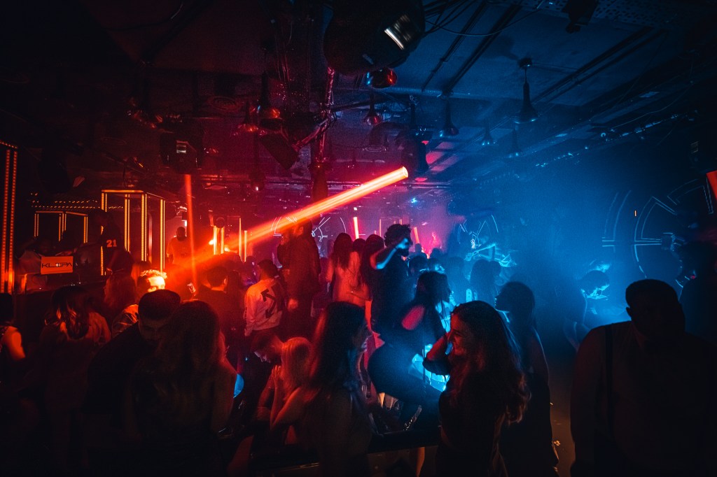 Guests dancing inside a high-end London club.